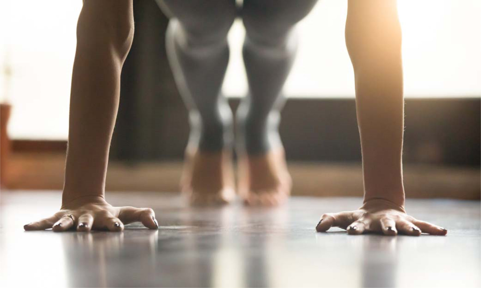 Young yogi woman standing in Plank pose, home interior backgroun
